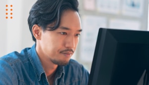 Man working at computer looking at database stuff