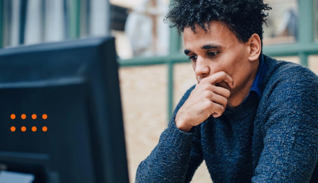 Man looks at computer reading about the future of SaaS