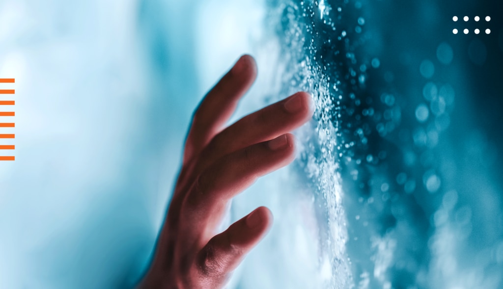 A human hand reaching out to touch a digital graphic effect that looks like mist or water