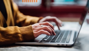 Person typing on the keypad of a laptop